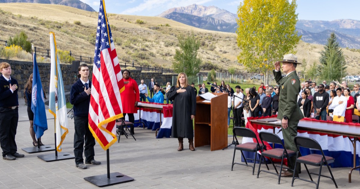 New citizens receiving small American flags during a naturalization ceremony